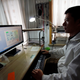 A lender on the PaiPaiDai platform works from his home in Shanghai in 2011.